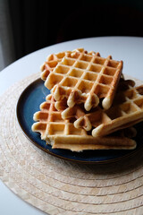 belgian waffles on a plate and a round napkin