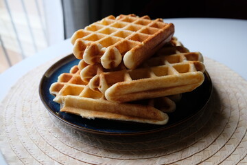 belgian waffles on blue plate and white table