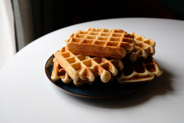 belgian waffles on blue plate and white table