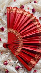 Elegant red hand fan with lace trim surrounded by rose petals, evoking romance, tradition, and cultural charm.
