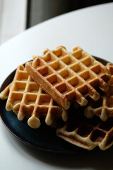 belgian waffles on blue plate and white table