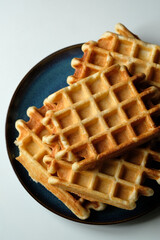 belgian waffles on blue plate and white table