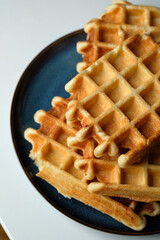 belgian waffles on blue plate and white table