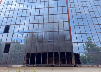 A burnt-out building with many windows and lots of glass