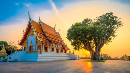 A serene photograph of a Thai Buddhist temple at sunset.