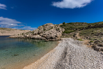 The picturesque bay and pebbly empty beach of Gnjilova on the island of KRK,