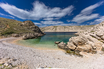 The picturesque bay and pebbly empty beach of Gnjilova on the island of KRK,