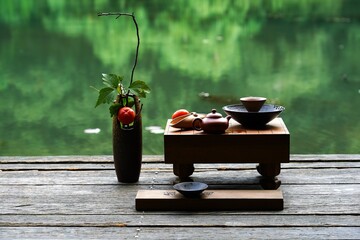 Traditional Japanese tea set on a wooden deck.