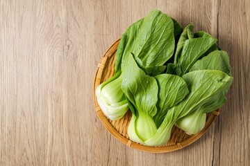 Green Pakchoi,Pak Choi,Bok Choy in a basket on wooden background