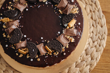 Chocolate homemade cake with icing and cream, festive birthday dessert