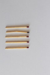 Burnt and Bent Matchstick Among New Ones: Symbol of Weakness or Collapse