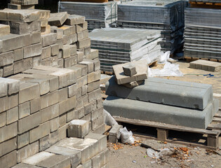 Carefully stacked dismantled old paving slabs and pallets with new ones