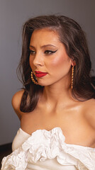 Stylish model with wavy hair and glamorous makeup. The photo captures her sophisticated style