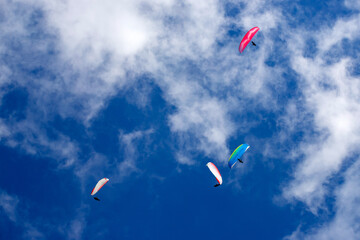 Paragliders above the alps in the dolomites, South Tyrol