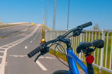 Bicycle close up at bike path in country near roadway in summer