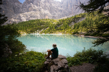 Travel woman man hiker at Sorapis Lake in the Dolomite Mountains