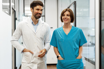 Doctors walking and talking in hospital corridor