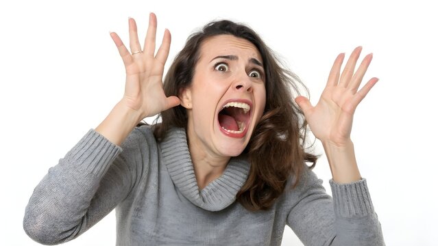 A woman with brown hair screams in terror, hands raised in a gesture of fear and panic.