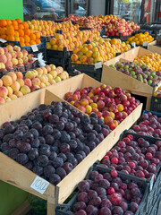 Colorful Fruit Market Stall with Stone Fruits and Handwritten Price Tags