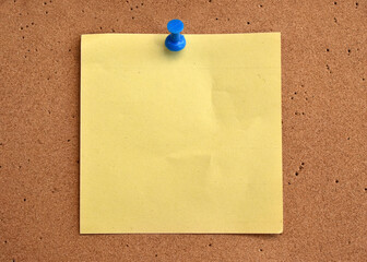 Colorful notes on a cork wall with a pin
