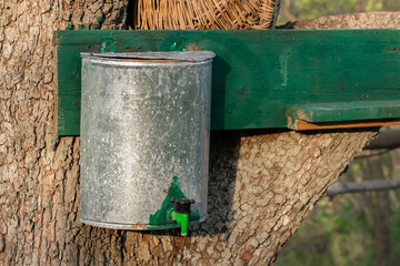 Metal rustic hand wash basin on wood.