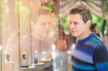 Man Contemplating Watches Through Store Window