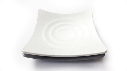 Stack of empty square white and grey plates with ceramic melamin material isolated on white background