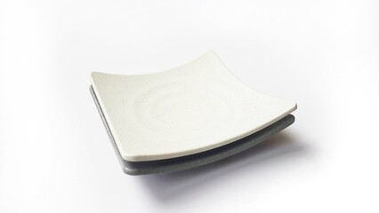 Stack of empty square white and grey plates with ceramic melamin material isolated on white background