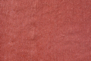 Top view photo of  orange colored organic knitted cotton fabric