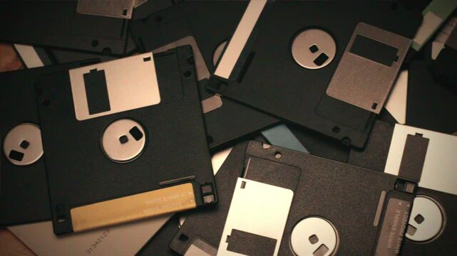 Floppy disc FDD close up, Using diskette for old PC computer macro. Archive programme or Music recorder, playing retro computer games. Vintage device for office, obsolete technology. 