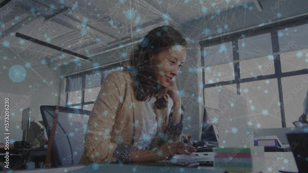 Poster ringing phone initiating client call while businesswoman typing notes under network-node overlay
