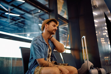 Tired traveler waiting to board on a plane at the airport.