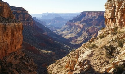 winding rocky cliffs over canyon, visible rock layers, clear sky, daylight shadow contrast