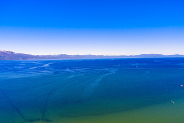 Aerial wide angle view of Lake Tahoe during summer. This image has recreational boats, fishing...
