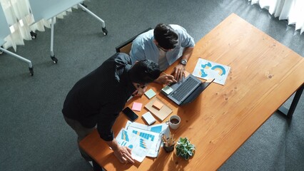 Skilled project manager walking at table while colleague brainstorm idea. Business team working...