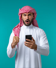 A arabic man in traditional Middle Eastern attire reacting strongly to something on his phon. arab man using mobile phone