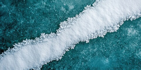 Diagonal split line running through frosty white surface on rich teal