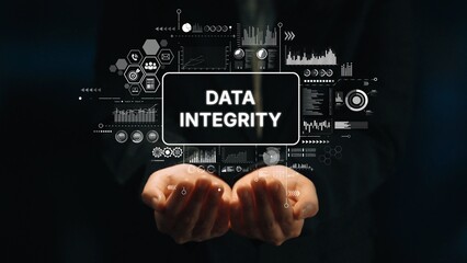 Hands Holding Data Integrity Concept with Digital Graphics and Visual Elements Amidst Dark...