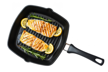 Two grilled fish fillets with lemon slices and rosemary in a grill pan cooking