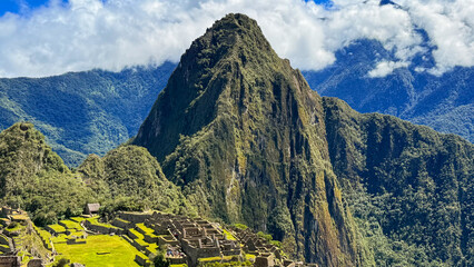 Scenic Aerial View of Machu Picchu Ruins with Iconic Huayna Picchu Mountain under Cloudy Sky in Peru