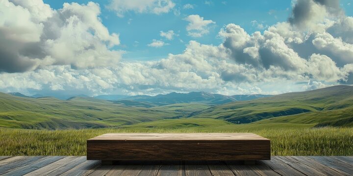 Woodgrain riser and monitor with backdrop of highlands and rolling clouds