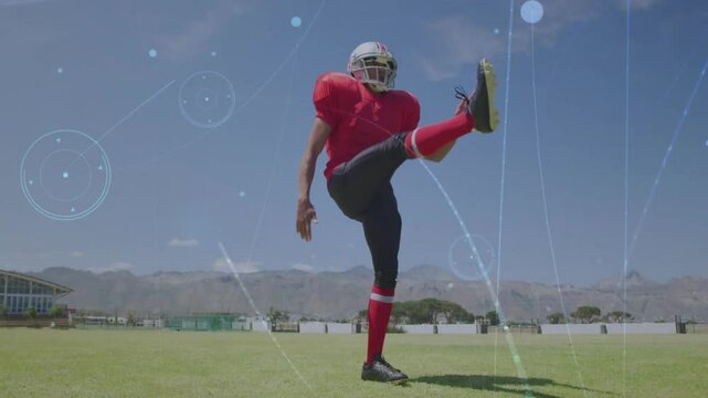 Football player shifting stance before punting ball while sports analytics overlays intensifying
