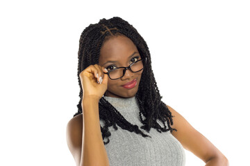 Black woman adjusting glasses with a skeptical expression, studio shot on white background