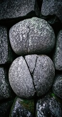 Close-up view of rough, gray stones, showing cracks and textures