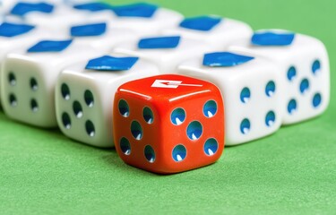 Single red die among many white dice on a green surface
