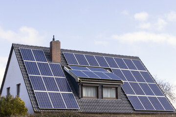 Gable roof with solar modules, solar energy, home energy storage, sustainability, rising...