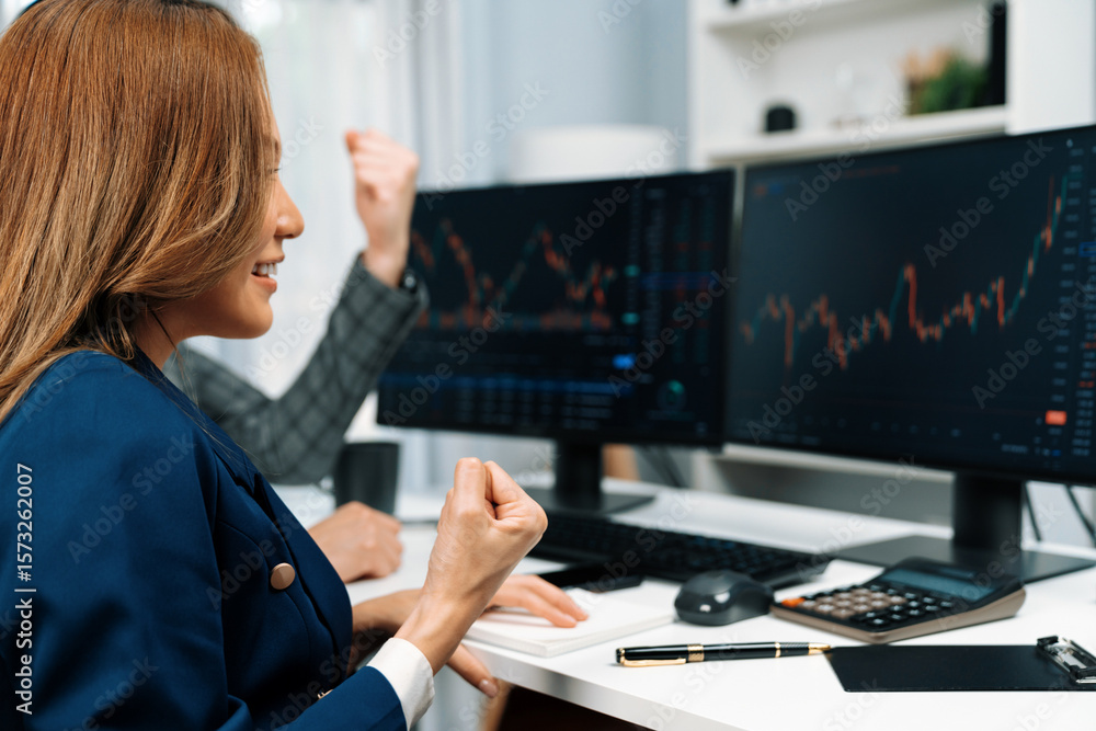 Poster cropped successful in smiling business partners raising fist up with profit stock market looking on 