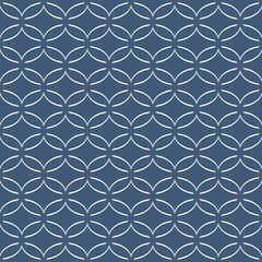 A symmetrical pattern of interlocking circles creates a repetitive geometric design on a gray background. The interconnected shapes form an intricate lattice that suggests elegance and simplicity.
