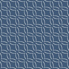 A repetitive circular pattern is formed by interconnected rings against a dark background, creating a geometric design. The minimalist arrangement adds an elegant touch to the overall visual.