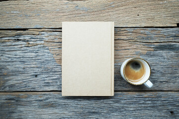 Notebook and coffee cup on table